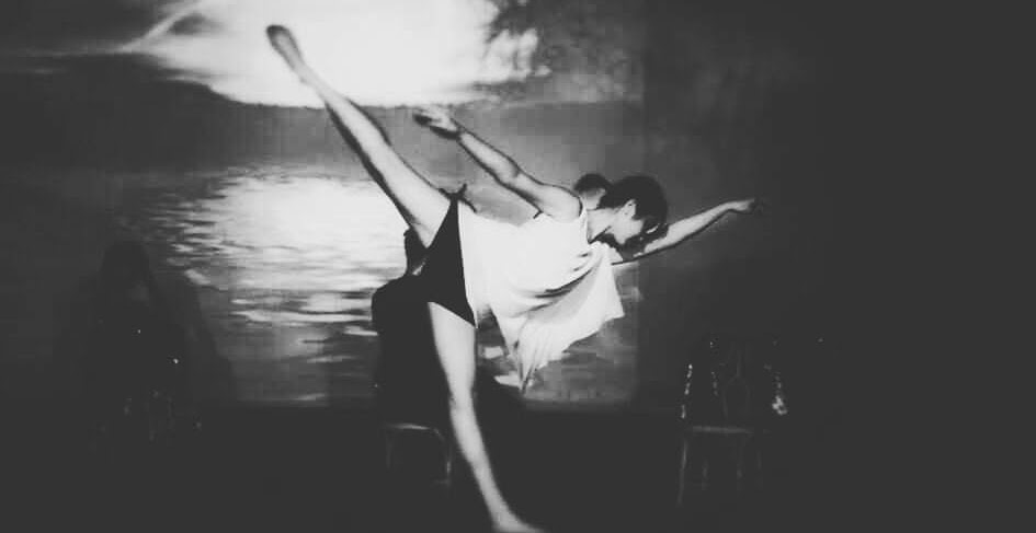 Verina performing contemporary choreography beside a projected landscape